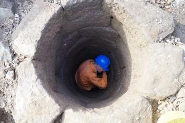 Brian, our smallest member of the team trying to further the well excavation