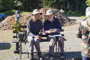 The Director and geologist discussing rock types