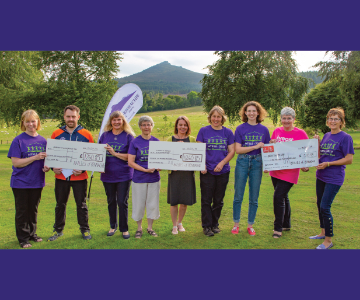 Members of the Bailies handing over cheques to the three charities